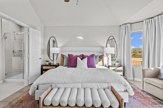 bedroom with ceiling fan, lofted ceiling, and ensuite bathroom