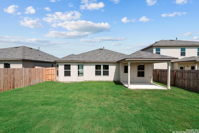 back of property featuring a patio area and a lawn