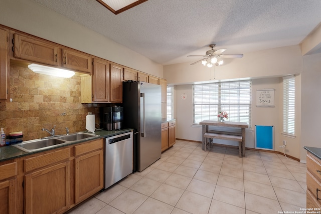 kitchen with ceiling fan, light tile patterned floors, sink, backsplash, and appliances with stainless steel finishes