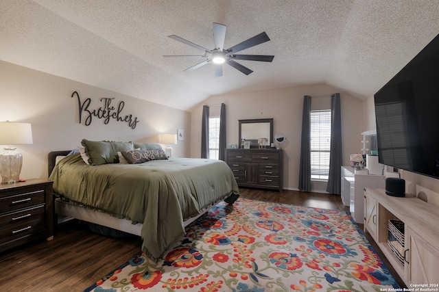 bedroom with a textured ceiling, vaulted ceiling, ceiling fan, and dark wood-type flooring