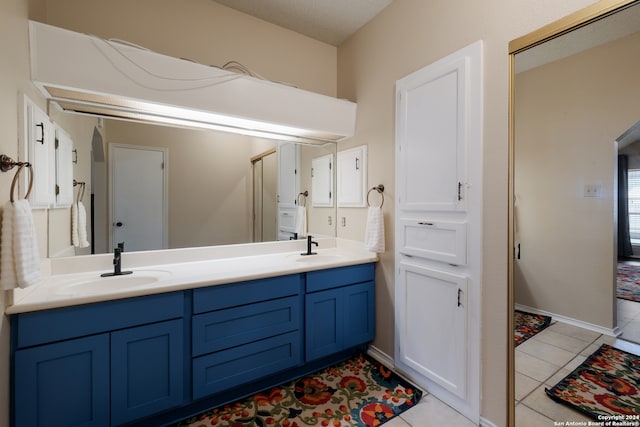 bathroom with tile patterned floors and vanity