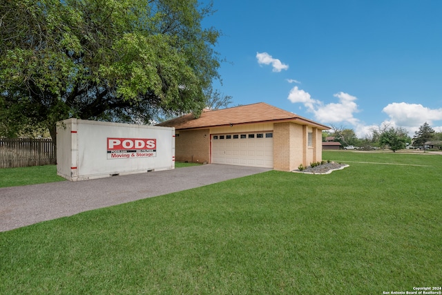 exterior space featuring a front lawn and a garage