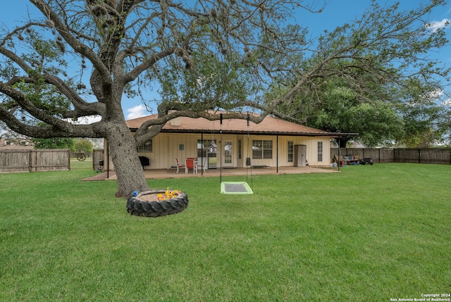 back of property featuring a yard and a patio area