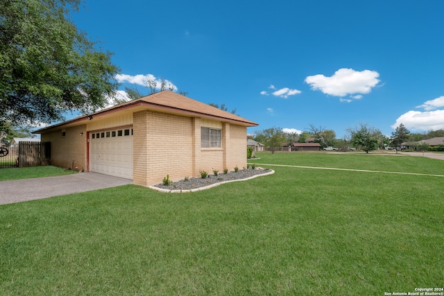 view of side of home featuring a yard and a garage