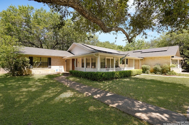 view of front of home featuring covered porch and a front yard