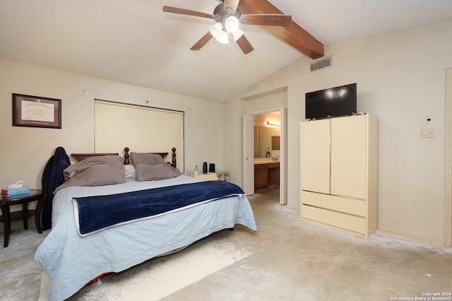 bedroom featuring connected bathroom, vaulted ceiling with beams, and ceiling fan