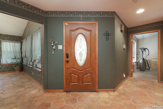 foyer entrance with a textured ceiling