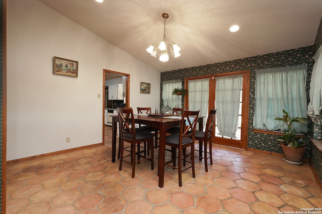 dining space featuring vaulted ceiling, an inviting chandelier, and a textured ceiling