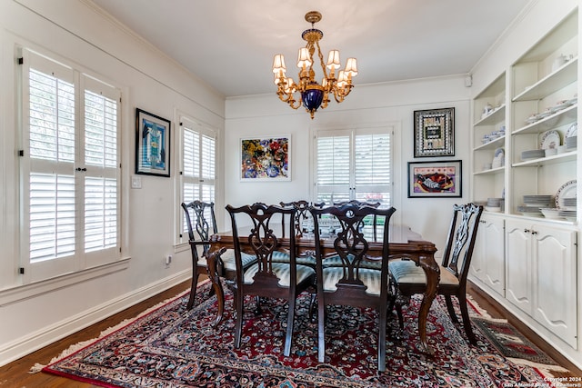 dining area with an inviting chandelier, ornamental molding, dark hardwood / wood-style floors, and a healthy amount of sunlight