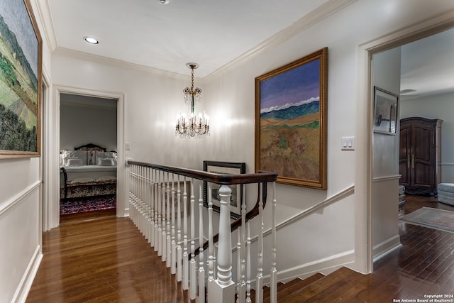 hall with ornamental molding, a chandelier, and dark hardwood / wood-style floors