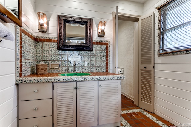 bathroom with wood walls and vanity