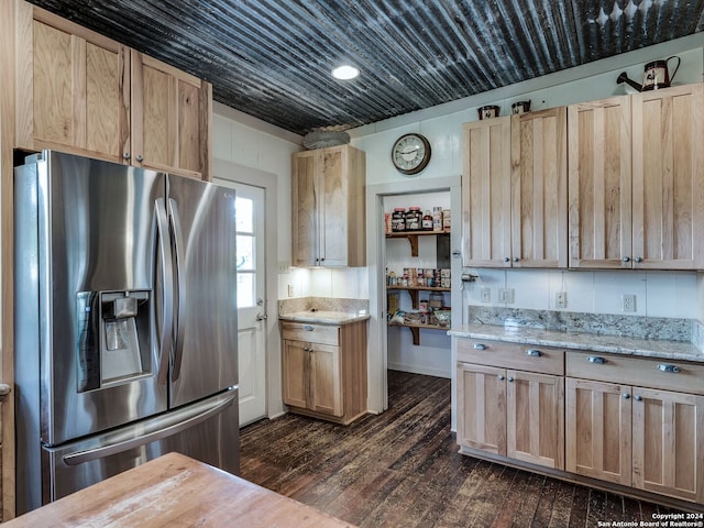 kitchen with light brown cabinetry, stainless steel fridge, dark wood-type flooring, and wooden counters