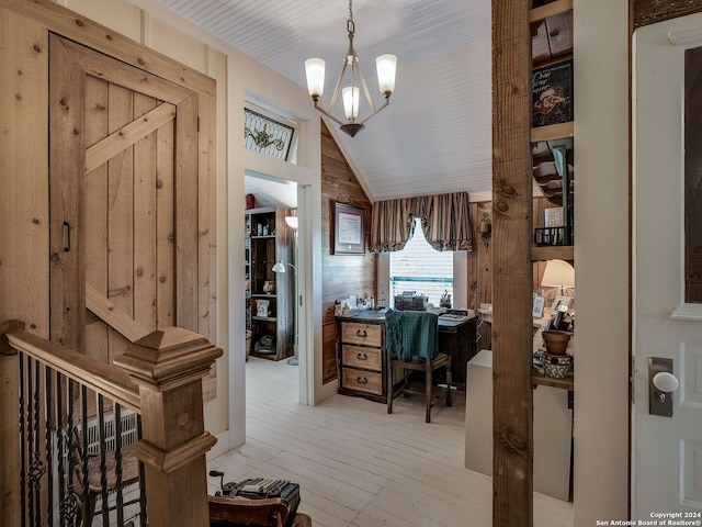 office with vaulted ceiling, light hardwood / wood-style flooring, and an inviting chandelier