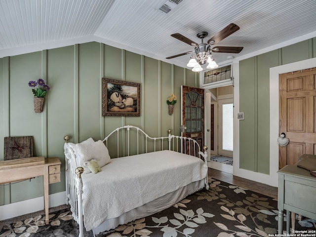 bedroom featuring ceiling fan, dark wood-type flooring, and vaulted ceiling