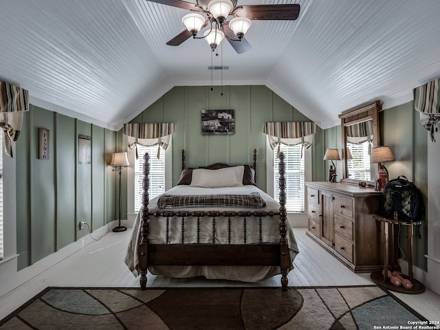 bedroom featuring ceiling fan, vaulted ceiling, and light wood-type flooring