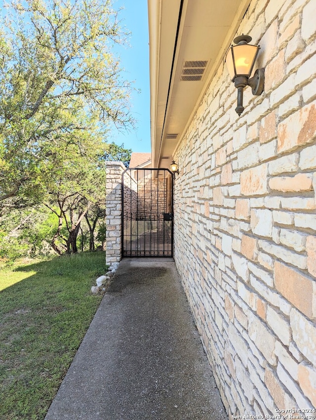 view of gate with a yard