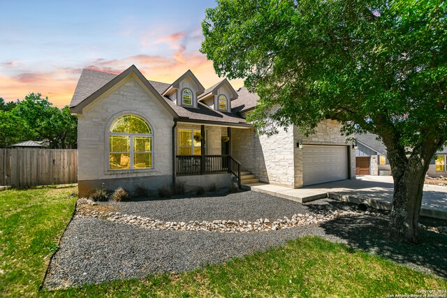 view of front of home featuring a porch and a garage