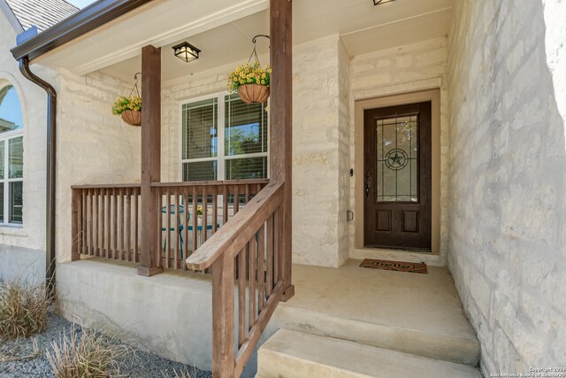 property entrance with covered porch