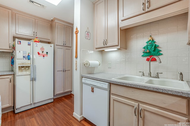 kitchen featuring backsplash, light brown cabinets, white appliances, and dark hardwood / wood-style floors