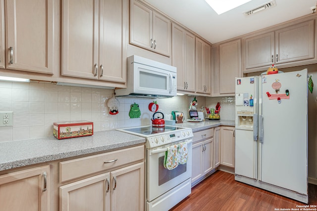 kitchen featuring light brown cabinetry, light stone counters, white appliances, backsplash, and dark hardwood / wood-style flooring