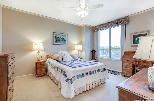 bedroom with ceiling fan, light colored carpet, and ornamental molding