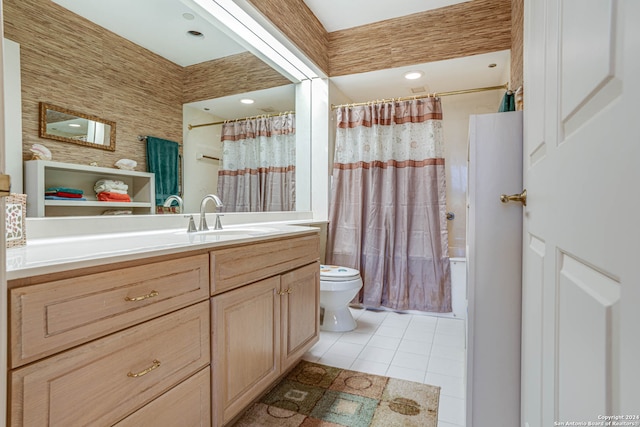 bathroom with toilet, tile floors, and vanity