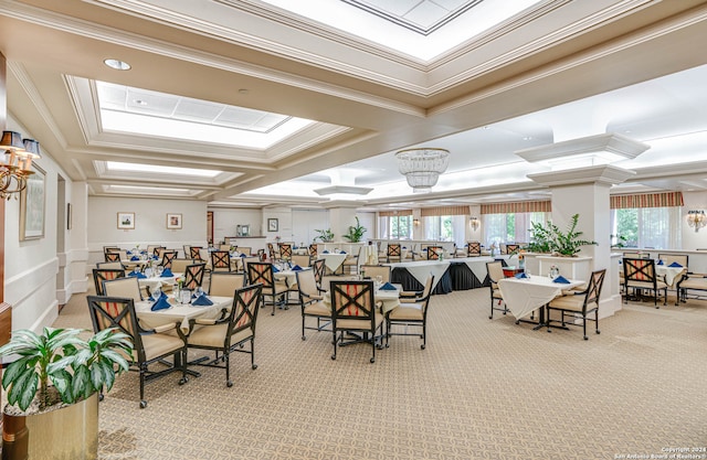 dining space with light carpet, a chandelier, coffered ceiling, and crown molding