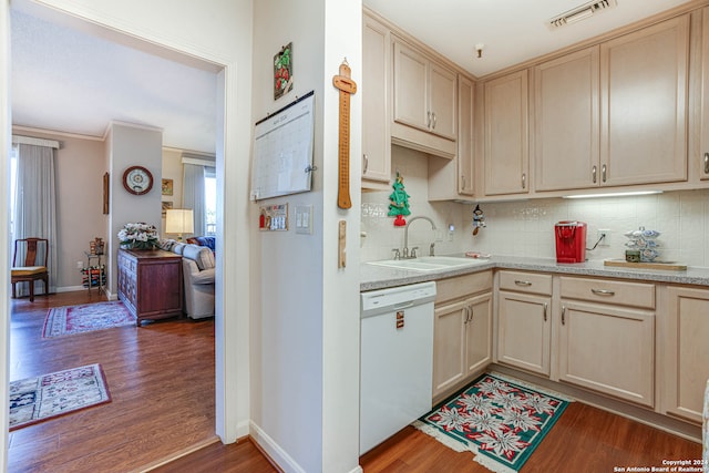 kitchen with sink, ornamental molding, dishwasher, dark wood-type flooring, and tasteful backsplash