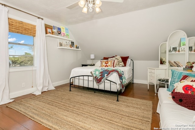 bedroom featuring a textured ceiling, dark wood-type flooring, ceiling fan, and lofted ceiling