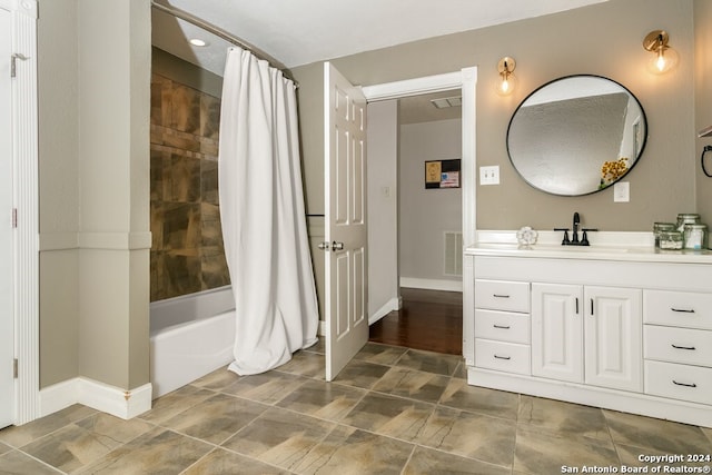 bathroom featuring vanity and shower / tub combo with curtain