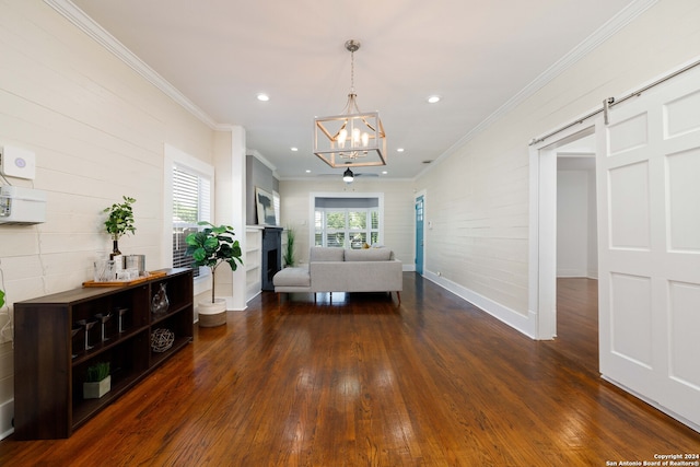 unfurnished bedroom featuring an inviting chandelier, dark hardwood / wood-style flooring, a barn door, and ornamental molding