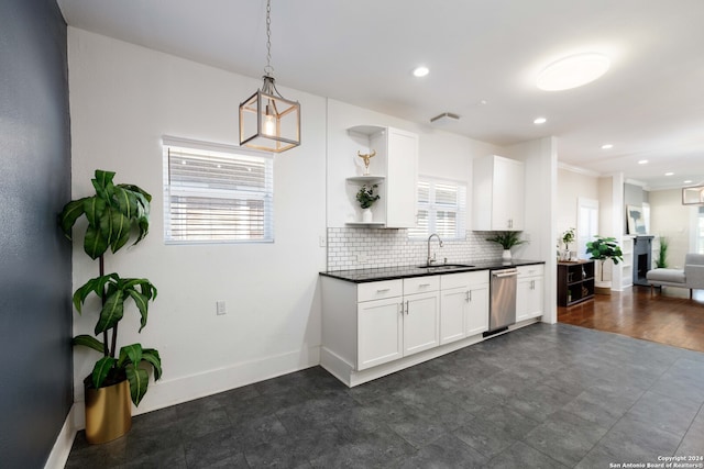 kitchen featuring dishwasher, tasteful backsplash, plenty of natural light, and dark wood-type flooring