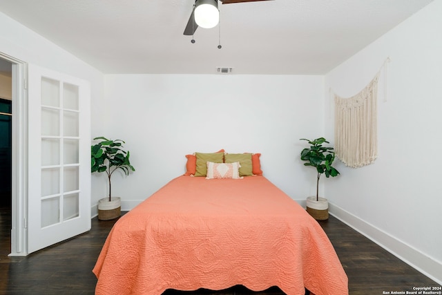 bedroom with dark hardwood / wood-style floors and ceiling fan