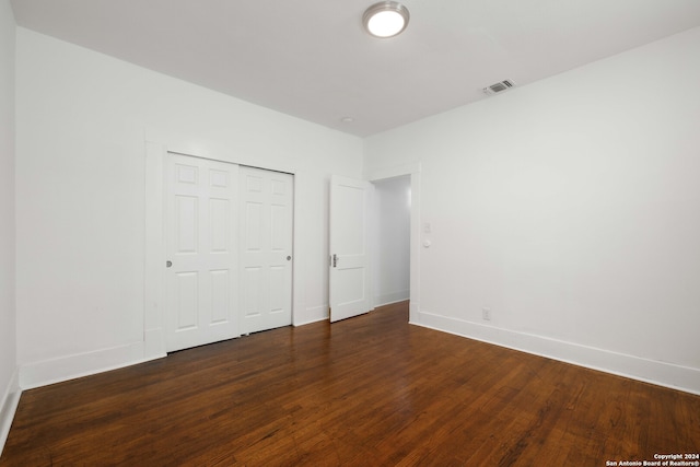 unfurnished bedroom with wood-type flooring and a closet