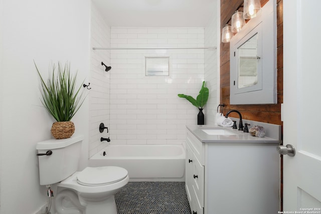 full bathroom with tile patterned flooring, tiled shower / bath combo, toilet, and vanity