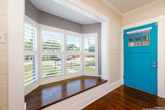 foyer entrance with wood-type flooring and crown molding