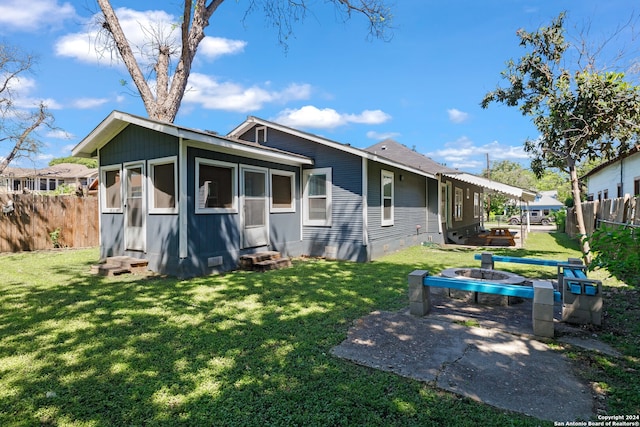 back of property featuring a lawn