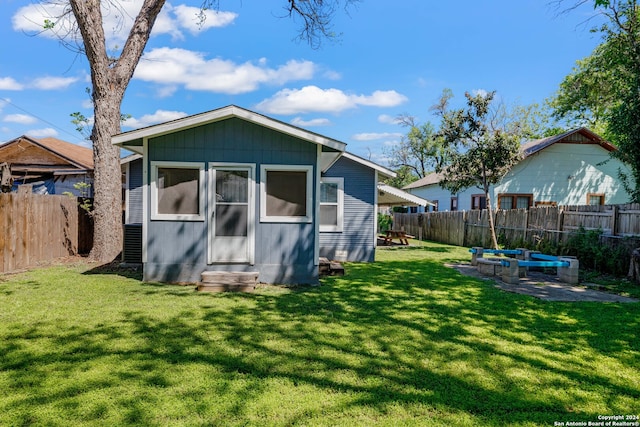 rear view of property with a lawn