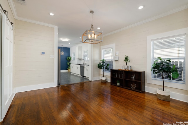 living room featuring a healthy amount of sunlight, sink, and hardwood / wood-style floors