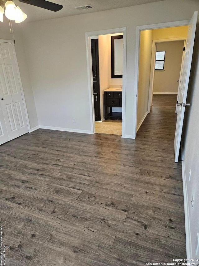 empty room featuring ceiling fan and dark wood-type flooring