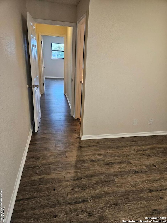 hallway with dark wood-type flooring