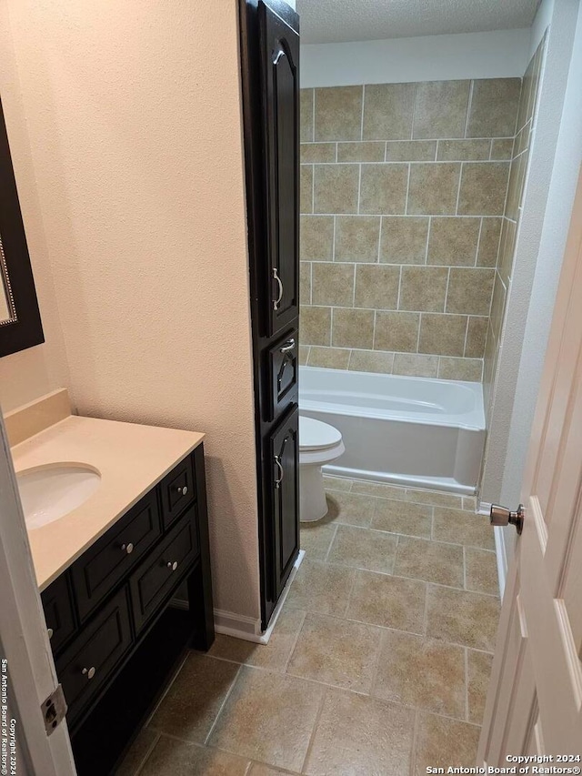 full bathroom with toilet, a textured ceiling, vanity, washtub / shower combination, and tile flooring