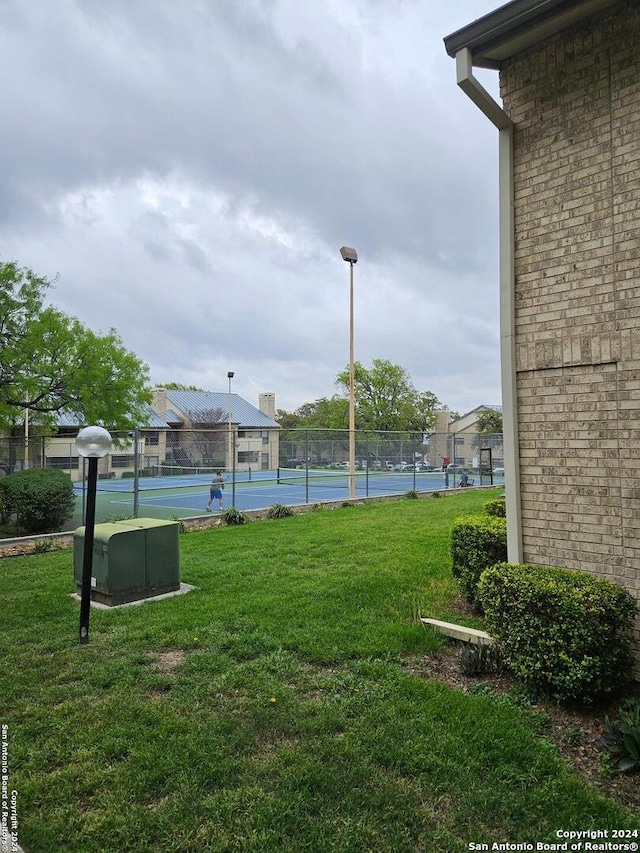 view of yard with tennis court