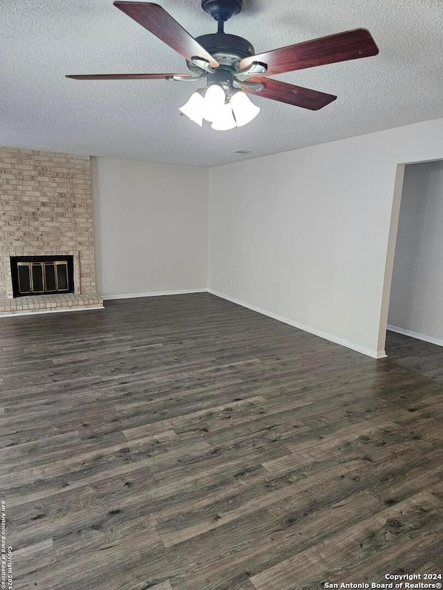 unfurnished living room featuring a textured ceiling, ceiling fan, and dark hardwood / wood-style floors