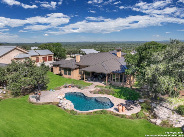 view of pool with a lawn and a patio