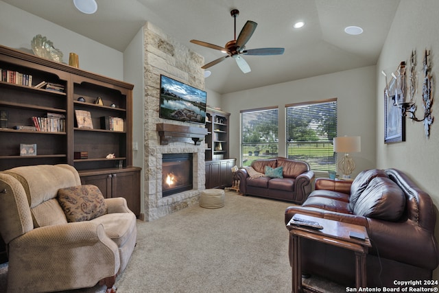 living room featuring carpet, lofted ceiling, ceiling fan, and a fireplace