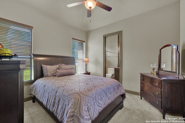 carpeted bedroom with ceiling fan, a spacious closet, ensuite bath, and a closet