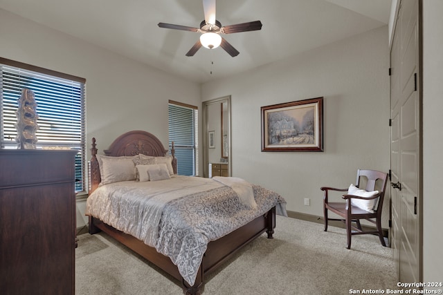 bedroom featuring ceiling fan and light carpet