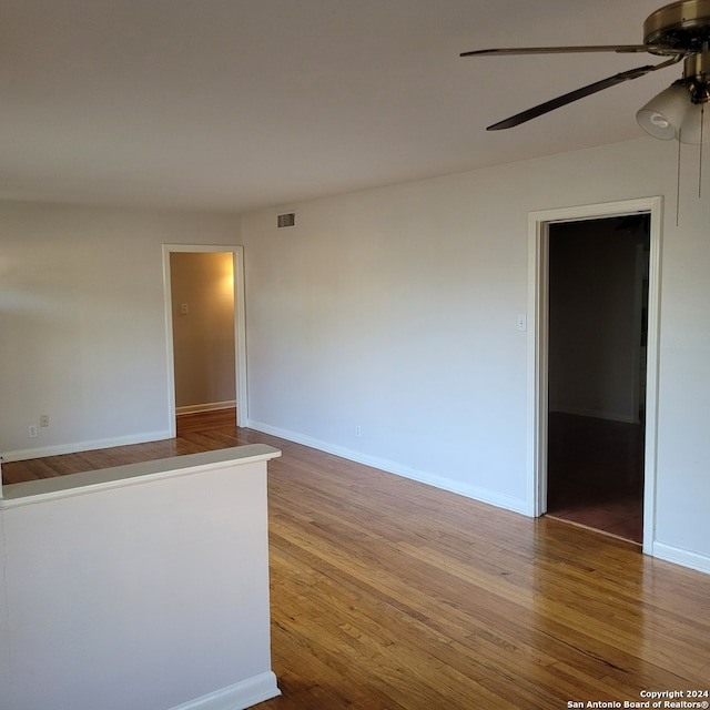 spare room featuring ceiling fan and hardwood / wood-style flooring