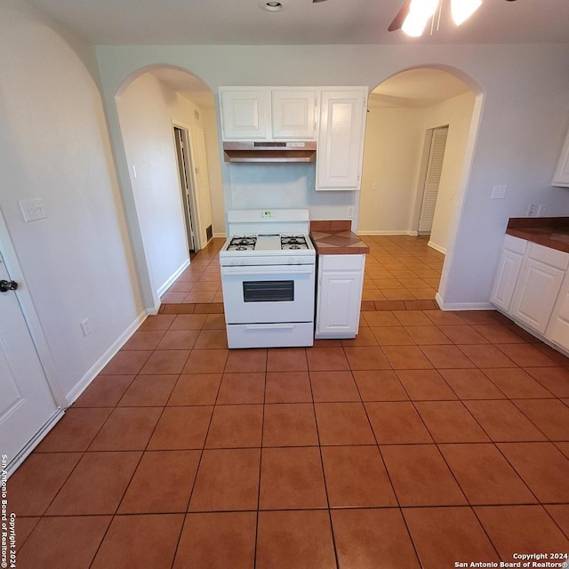 kitchen featuring ceiling fan, white range with gas stovetop, and tile floors